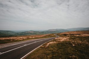 gray asphalt road under cloudy sky