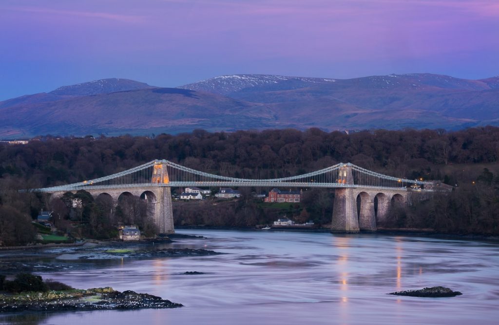 landscape photography of cable bridge near mountain range