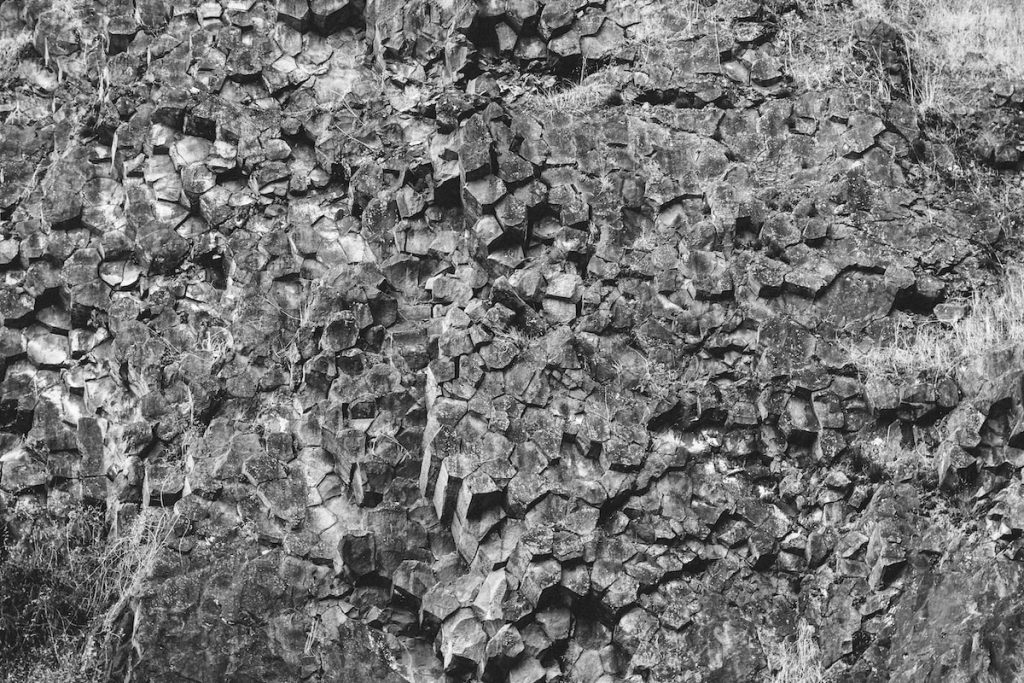 a black and white photo of a rock wall