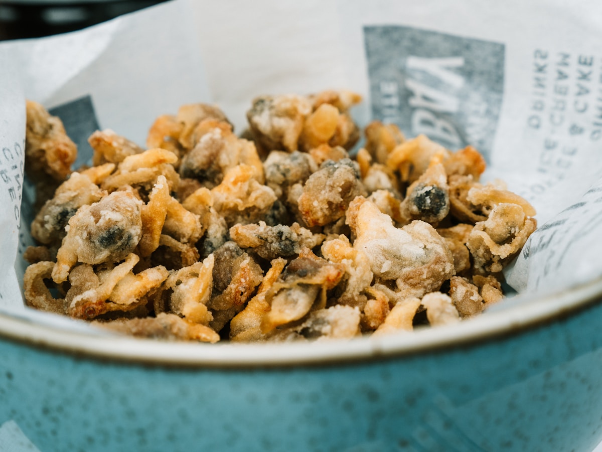 brown and white nuts on white ceramic bowl