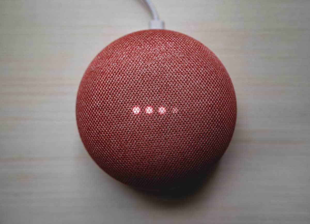 red round portable speaker on brown wooden table